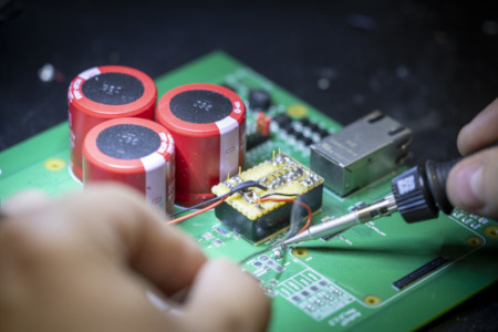 Closeup_image_soldering_PCB_prototype Closeup image of soldering modifications to a prototybe audio amplifier PCB